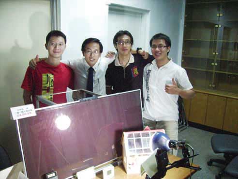 Dr. C.H. Young, (second from left), and his team unveil a unique glazing that cleans itself, generates electricity, and reduces incoming heat. 