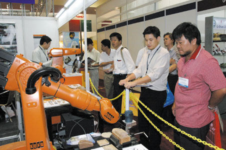 Visitors are intrigued by various advanced machines at Aseanwood-Woodtech Malaysia.  