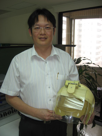 Jerry Tseng, general manager of HaiHao, holds the first-generation, mouth-operated wiper helmet.