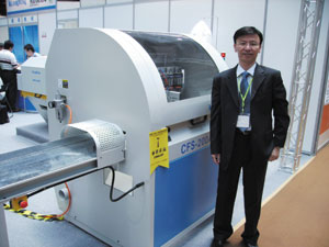 Kuang Yung`s general manager Joe Chang and with his company`s CFS-200A semi-optimizing cut-off saw.