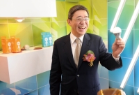W.C. Wang demonstrates an LED light bulb to be soon made on Nanya's fully automated line. 
