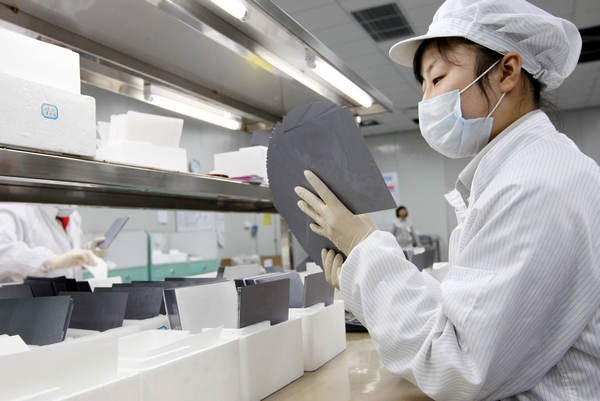 Hit by antidumping measures, mainland China’s PV-equipment manufacturers are cutting production. Pictured is a Chinese solar wafer production line.(photo courtesy of GCL-Poly)