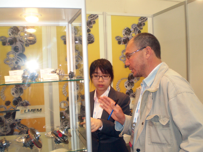 Tracy Yen (left), sales executive from Elmen Precision, introduces turbocharger parts.