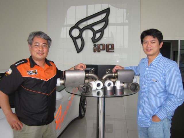 Gary Chien (right), president of Jim Technology, and Gela Wu, vice president of the company, showcase an iPE-branded top-end exhaust system made of titanium alloy for a supercar model.